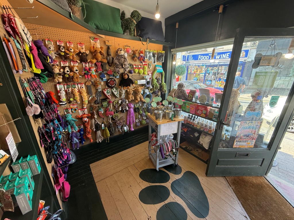 Lot: 113 - PAIR OF SHOPS AND SELF-CONTAINED FLAT FOR INVESTMENT WITH PART VACANT POSSESSION - Inside of dog shop with fully stocked shelves